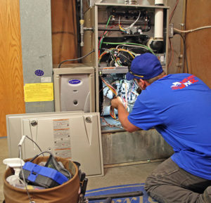 HVAC tech installing heating system in home